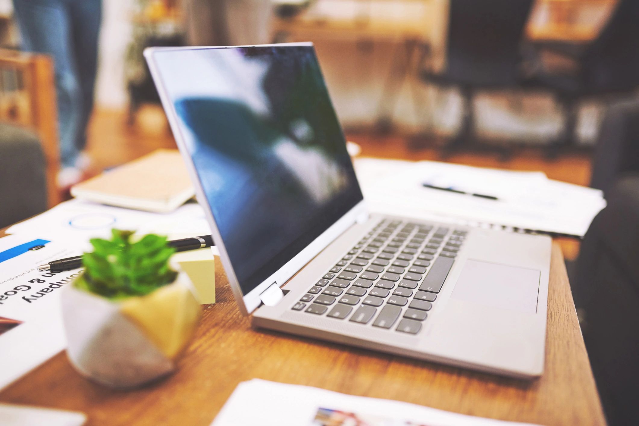 Laptop and printed materials arranged on a desk for resource planning